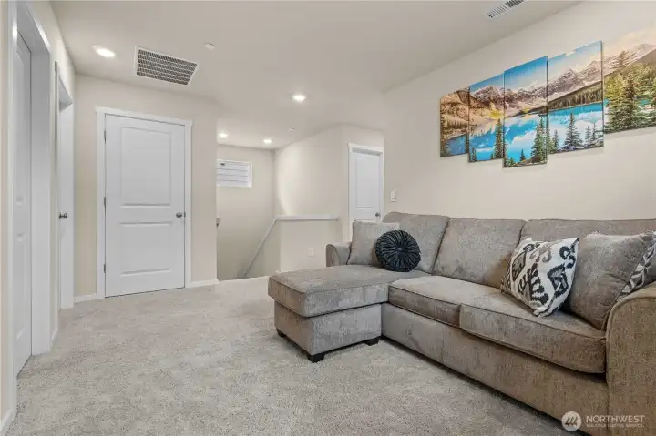 Versatile loft space perfect for a media room, office, playroom, or flex space.