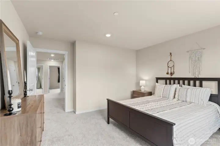Large primary bedroom featuring ample space for relaxation and comfort.