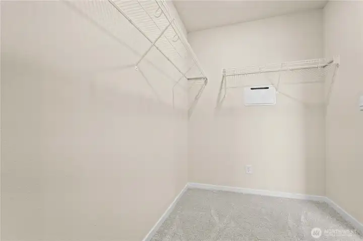 Large walk-in closet designed to maximize storage space.