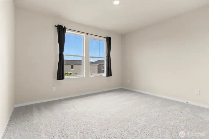 Comfortable secondary bedroom with natural light and versatile use.