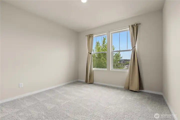 Additional bedroom ideal for guests, family, or home office needs.