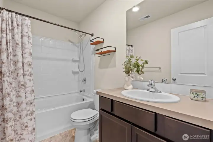 Upstairs full bath featuring modern fixtures and convenient access to bedrooms.