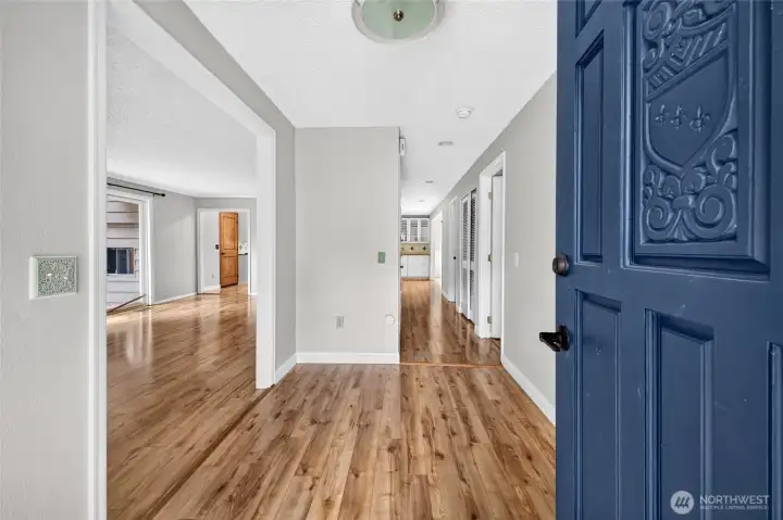 Additional view of the entry showcasing the wide hallway, open floor plan, and level flooring throughout the main living areas. These thoughtful design features provide a spacious, open feel and may appeal to buyers seeking a home with accessibility-friendly characteristics. Additional view of the entry showcasing the wide hallway, open floor plan, and level flooring throughout the main living areas. These thoughtful design features provide a spacious, open feel and may appeal to buyers seeking a home with accessibility-friendly characteristics.
