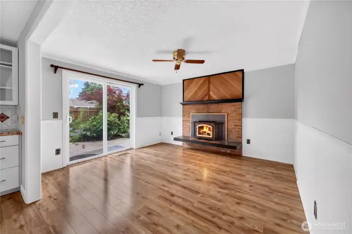 The family room features a fireplace, ceiling fan and access to a large deck. The family room features a fireplace, ceiling fan and access to a large deck.
