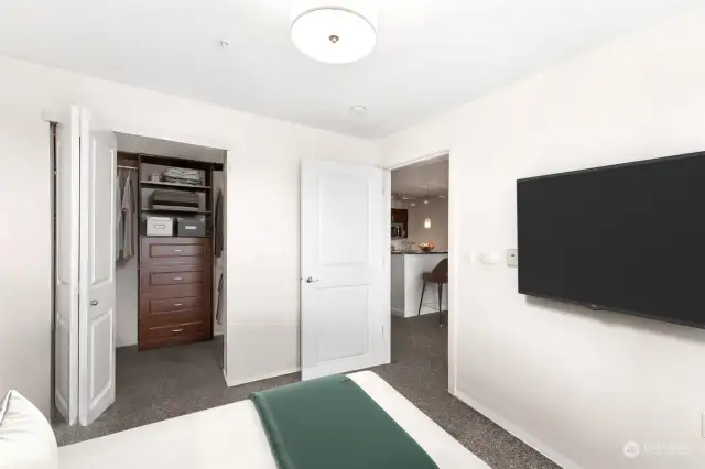 Bedroom closet features built-ins & lots of hanging space (Virtually-staged)