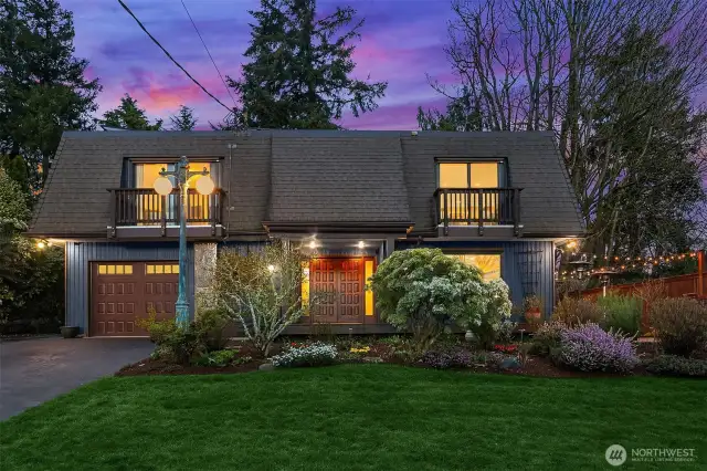 This remarkable Shorewood on the Sound residence projects vintage elegance with its French roof and its lush surrounding gardens.