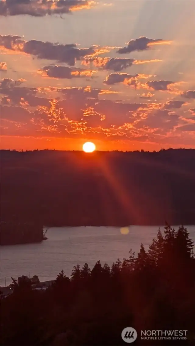Seller photo of an incredible sunset they watched from the deck, one of their favorite things about the home!