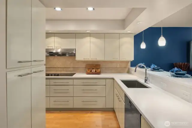Artistic tile backsplashes accentuate the brand-new quartz slab counters, handcrafted cabinets, and newer appliances.