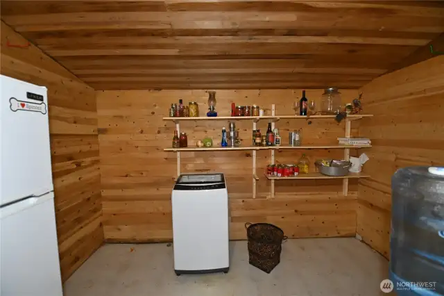 A generous sized pantry offers plenty of space for staying organized. Equipped with a gas refrigerator and washer for off-grid convenience.