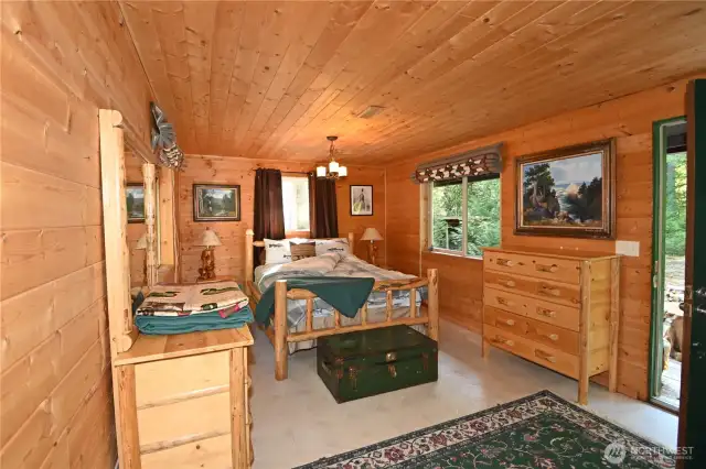 Main level bedroom with access to your private deck. *Montana log furniture included.