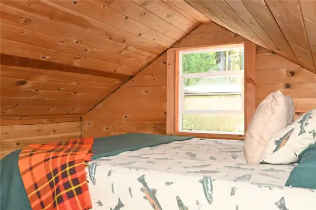 Loft sleeping offers forest views and the tranquil sound of the nearby river.