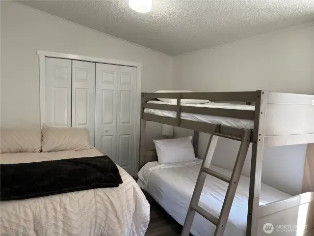 1. Bedroom with a queen size bed and a bunk bed