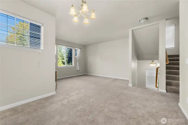 From the foyer there are stairs that lead to the formal living room and the dining room with views to the valley