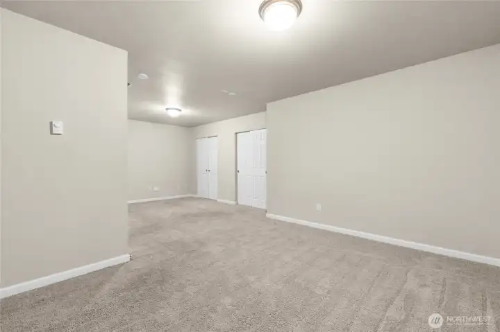 Ground level, daylight basement 4th.  The home has a two car garage that leads onto the ground level with hallway to full bathroom, storage closet and this 4th bedroom which is a rec room sized room with two windows and quadruple wide closets!  There is an over head outlet for plugging in a projector screen