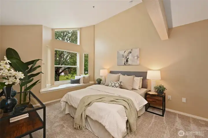 The Primary Suite with its vaulted ceilings and a flood of natural light beckons you to relax and recharge.