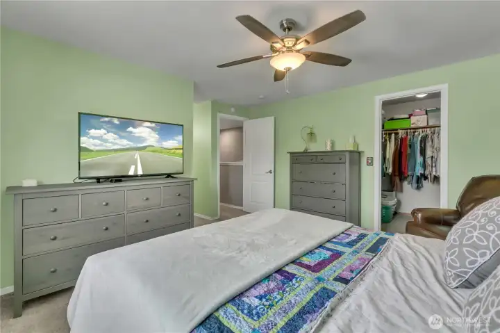 Walk in closet and ceiling fan in the primary