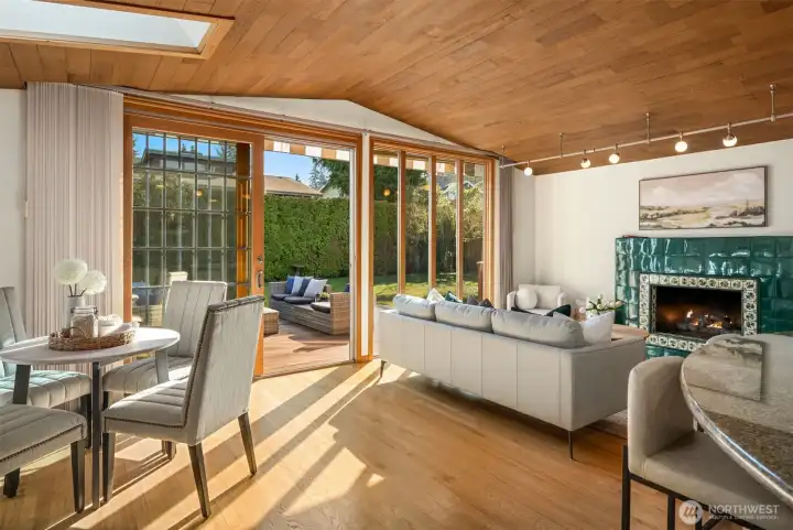 A light-filled family room where the expansive glass doors open directly onto the spacious deck and lush backyard beyond — a seamless indoor-outdoor connection that makes everyday living feel like a permanent retreat.