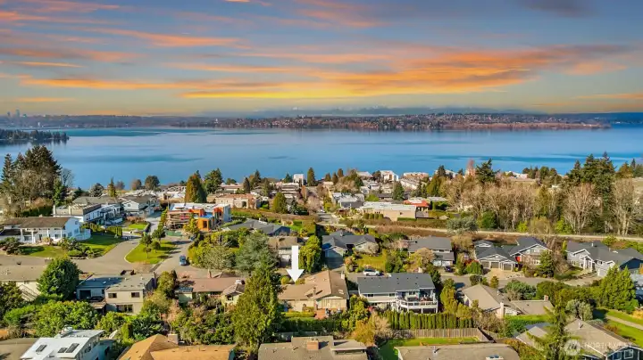 A stunning aerial view perfectly illustrating the home's unbeatable location — with the Cross Kirkland Corridor trail and the glistening waters of Lake Washington both just blocks away, nestled within a serene, tree-lined neighborhood that offers the rare combination of nature, recreation, and community right outside the front door.