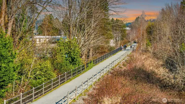 A scenic view of the Cross Kirkland Corridor — Kirkland's beloved premier walking and biking trail — just steps from the front door, winding through lush native trees and offering miles of car-free recreation right at your doorstep, perfectly embodying the active Pacific Northwest lifestyle.