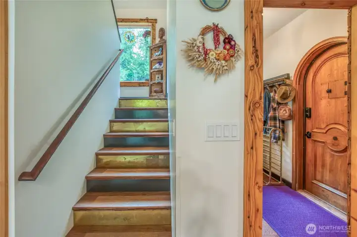 A light-filled staircase leads to the upper level with two bedrooms and a bath with washer and dryer, enhanced by a picture window at the landing.