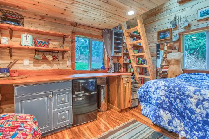 Thoughtfully put together, with a ladder leading to the loft and windows throughout bringing in soft natural light.