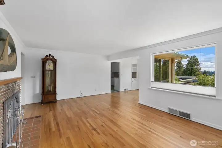 Living area with large windows overlooking backyard