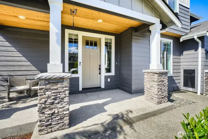 Welcoming covered front porch with stone accents creates the perfect place to relax and greet guests year-round. Welcoming covered front porch with stone accents creates the perfect place to relax and greet guests year-round.