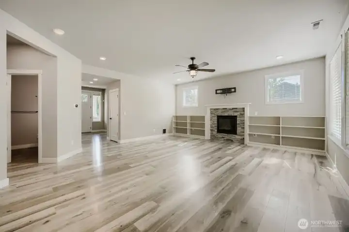 Expansive great room offers abundant natural light, custom built-in shelving, and a cozy fireplace that anchors the space. Expansive great room offers abundant natural light, custom built-in shelving, and a cozy fireplace that anchors the space.