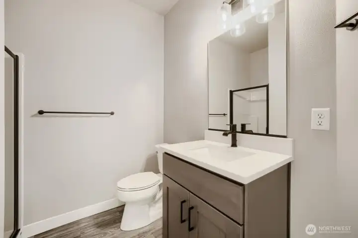 Stylish main-floor bathroom features modern fixtures, quartz countertops, and contemporary finishes. Stylish main-floor bathroom features modern fixtures, quartz countertops, and contemporary finishes.
