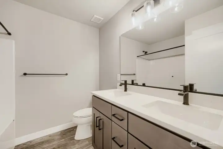 Additional guest bath features double sinks and tub. Additional guest bath features double sinks and tub.