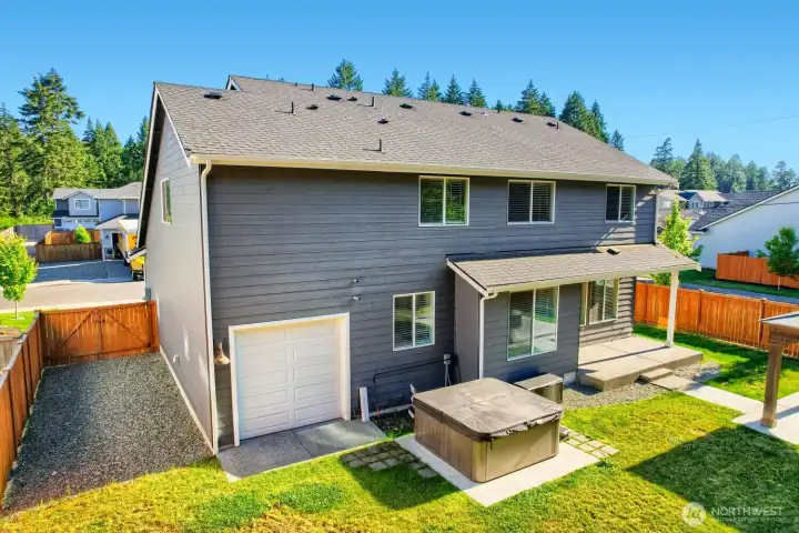 Expansive backyard features covered outdoor living space, hot tub area, and convenient side-yard access. Expansive backyard features covered outdoor living space, hot tub area, and convenient side-yard access.