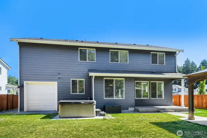 Private backyard retreat features covered outdoor living space, hot tub area, and room to relax or entertain. Private backyard retreat features covered outdoor living space, hot tub area, and room to relax or entertain.