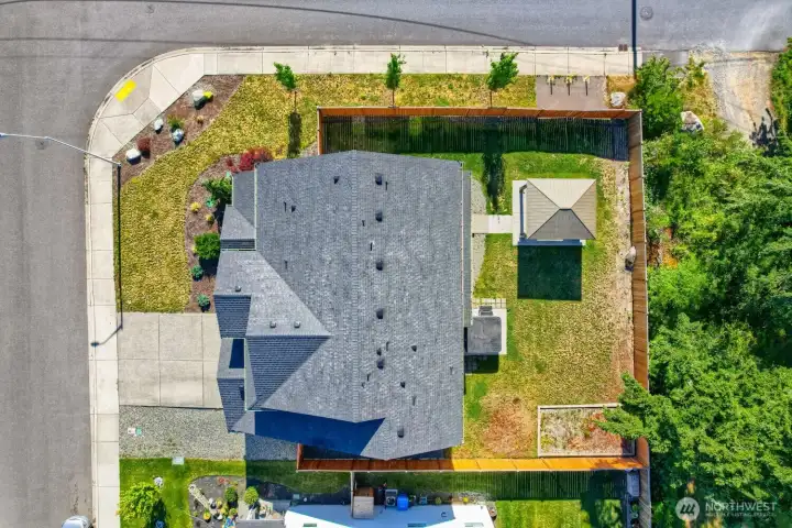 Bird’s-eye view highlights the generous corner lot, fenced yard, gazebo, and green surroundings. Bird’s-eye view highlights the generous corner lot, fenced yard, gazebo, and green surroundings.