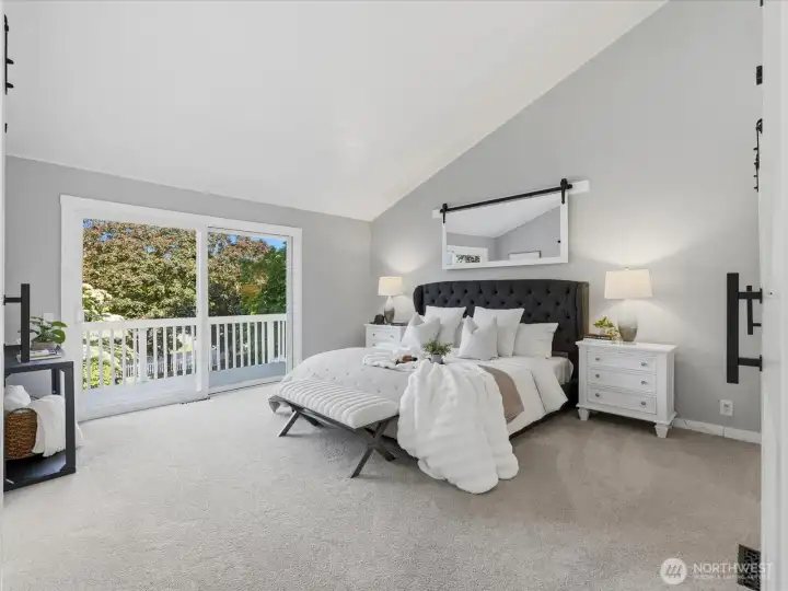 Main floor primary bedroom with private patio to enjoy the property view.