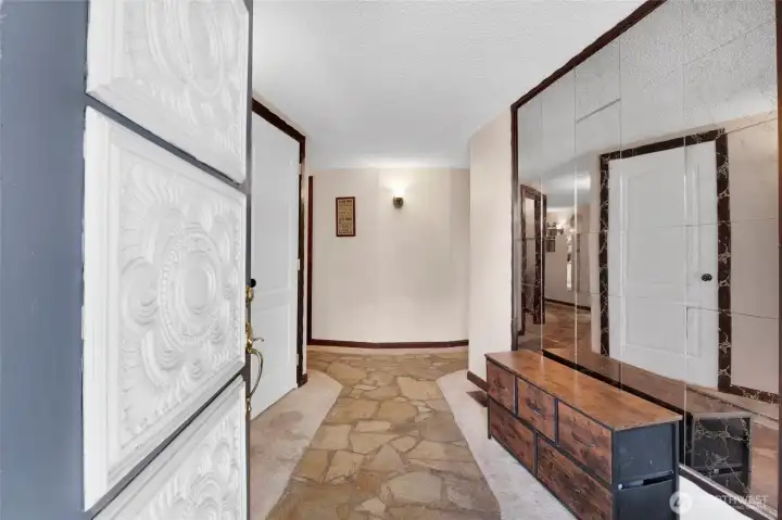 As you enter the front door to the foyer of this amazing round home, the basement door is to your left. Have you wanted to go down a quaint brick road? Well, this is almost the same as you walk on the flat stones through the hallways of this home to all the rooms of the house.