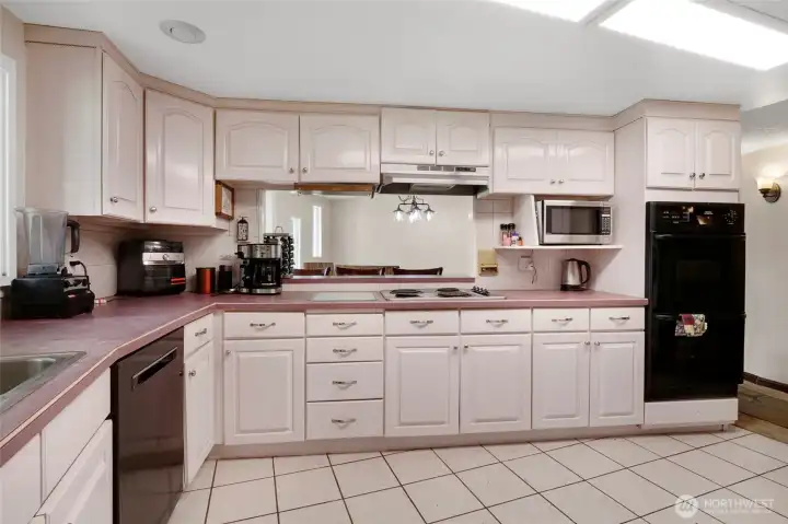 Another view from inside the kitchen, viewing into the dining area through the pass-through. The color palette of the cupboards is quite stunning!