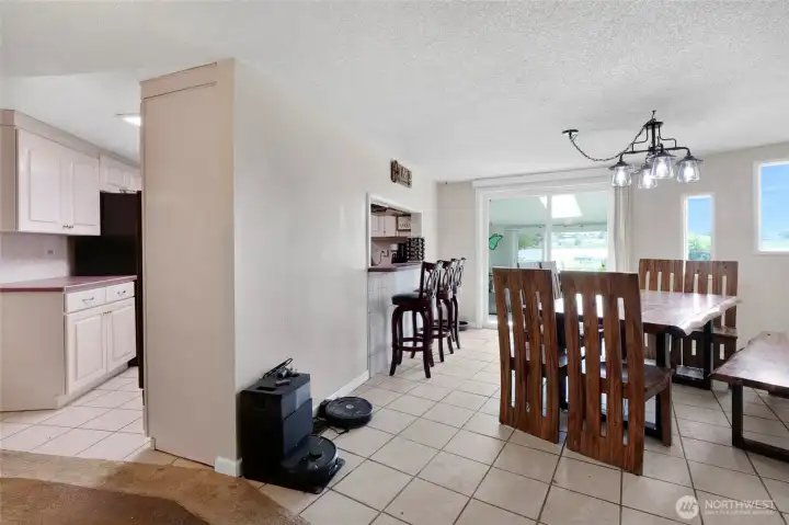 The kitchen and dining room face the sunroom at the back of the home so you can head right out to the lake and firepit after chores are done!