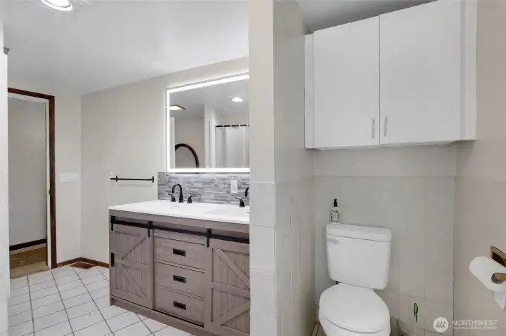 One of three bathrooms, with tile flooring and a bathtub/shower combo.