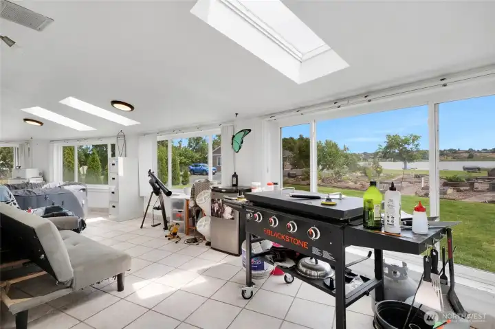This massive sunroom is perfect for relaxing and entertaining. Note the hot tub to the left! The sliding glass door to the right leads out to the backyard.