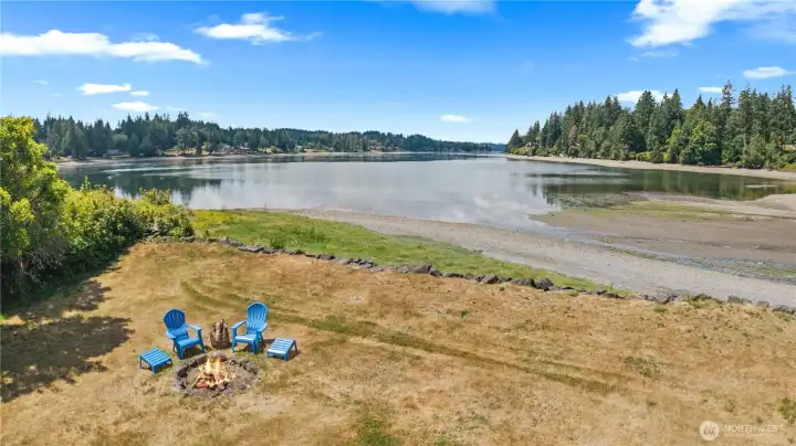Enjoy sunsets from the spacious waterfront lawn featuring Adirondack chairs, picnic area, and direct beach access. Enjoy sunsets from the spacious waterfront lawn featuring Adirondack chairs, picnic area, and direct beach access.