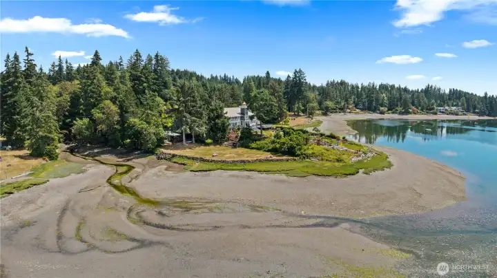 Elevated view of the property's private shoreline, tidal beach, and peaceful waterfront setting on Hammersley Inlet. Elevated view of the property's private shoreline, tidal beach, and peaceful waterfront setting on Hammersley Inlet.