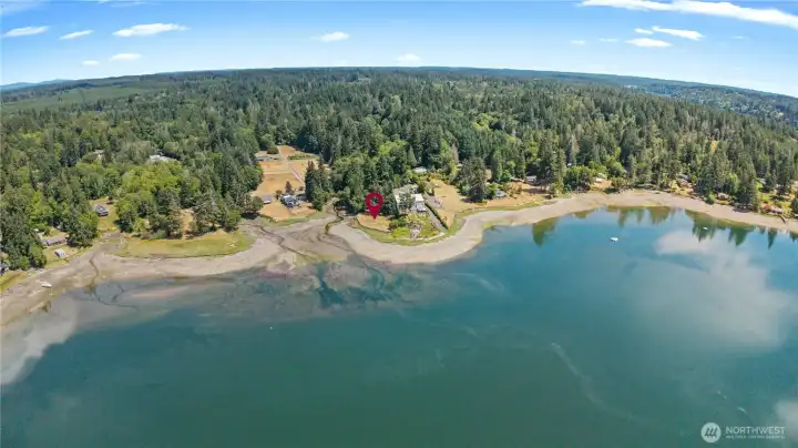 Bird's-eye view highlighting the secluded waterfront location surrounded by mature Pacific Northwest evergreens. Bird's-eye view highlighting the secluded waterfront location surrounded by mature Pacific Northwest evergreens.