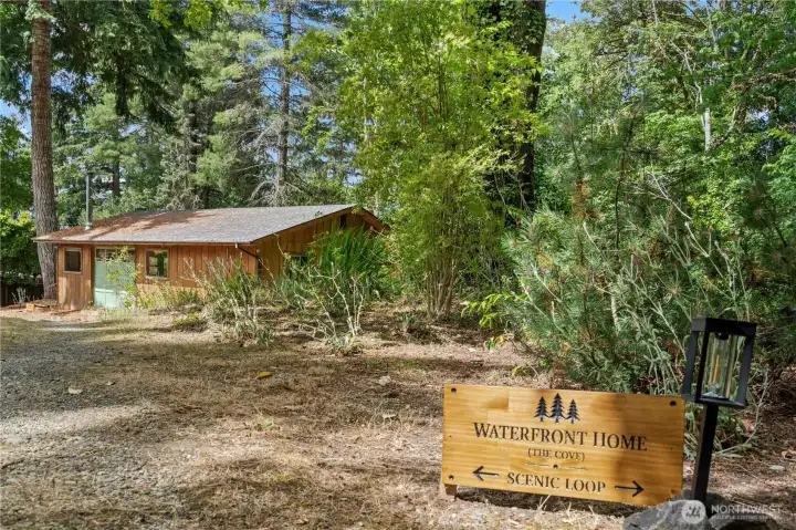 Approach to the charming coastal cabin surrounded by mature landscaping and natural beauty. Approach to the charming coastal cabin surrounded by mature landscaping and natural beauty.