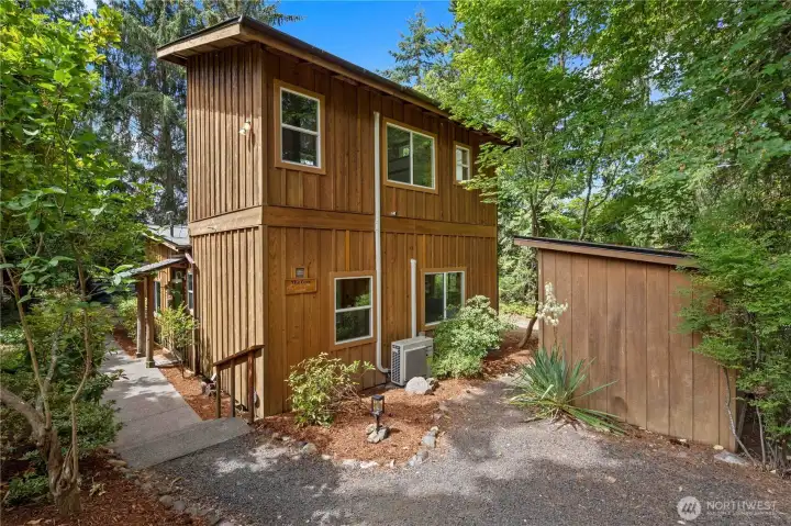 Contemporary waterfront home featuring warm cedar siding and a peaceful wooded setting just steps from the shoreline. Contemporary waterfront home featuring warm cedar siding and a peaceful wooded setting just steps from the shoreline.