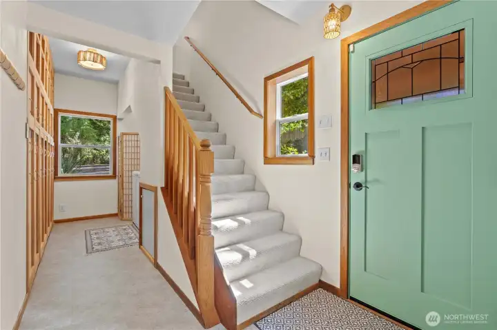 Bright entry with soaring ceilings, natural wood accents, and access to the upper level. Bright entry with soaring ceilings, natural wood accents, and access to the upper level.