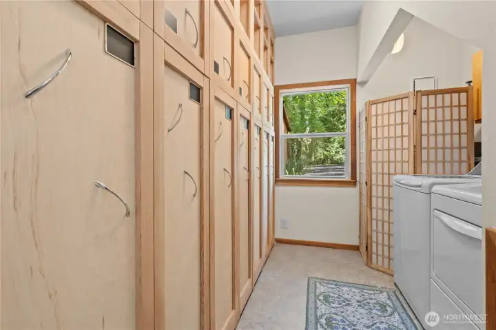 Functional mudroom and laundry area with built-in storage ideal for waterfront living. Functional mudroom and laundry area with built-in storage ideal for waterfront living.
