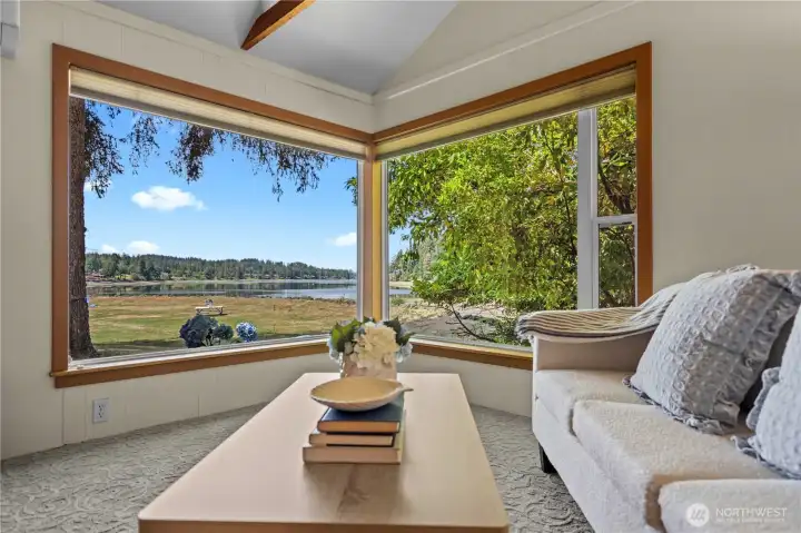 Living room framed by expansive picture windows capturing breathtaking Hammersley Inlet waterfront views. Living room framed by expansive picture windows capturing breathtaking Hammersley Inlet waterfront views.