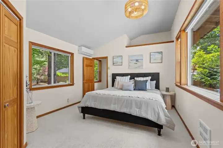 Spacious primary suite featuring peaceful natural views and abundant sunlight. Spacious primary suite featuring peaceful natural views and abundant sunlight.