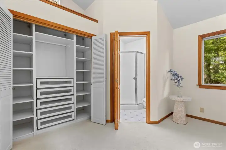 Walk-in closet with custom built-in shelving provides excellent storage and organization. Walk-in closet with custom built-in shelving provides excellent storage and organization.