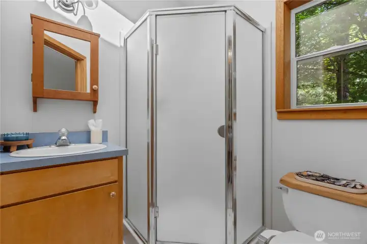Updated bathroom with walk-in shower and warm coastal-inspired finishes. Updated bathroom with walk-in shower and warm coastal-inspired finishes.